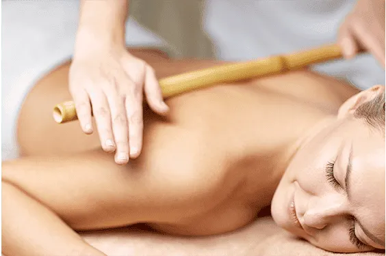 Back massage using a bamboo cane